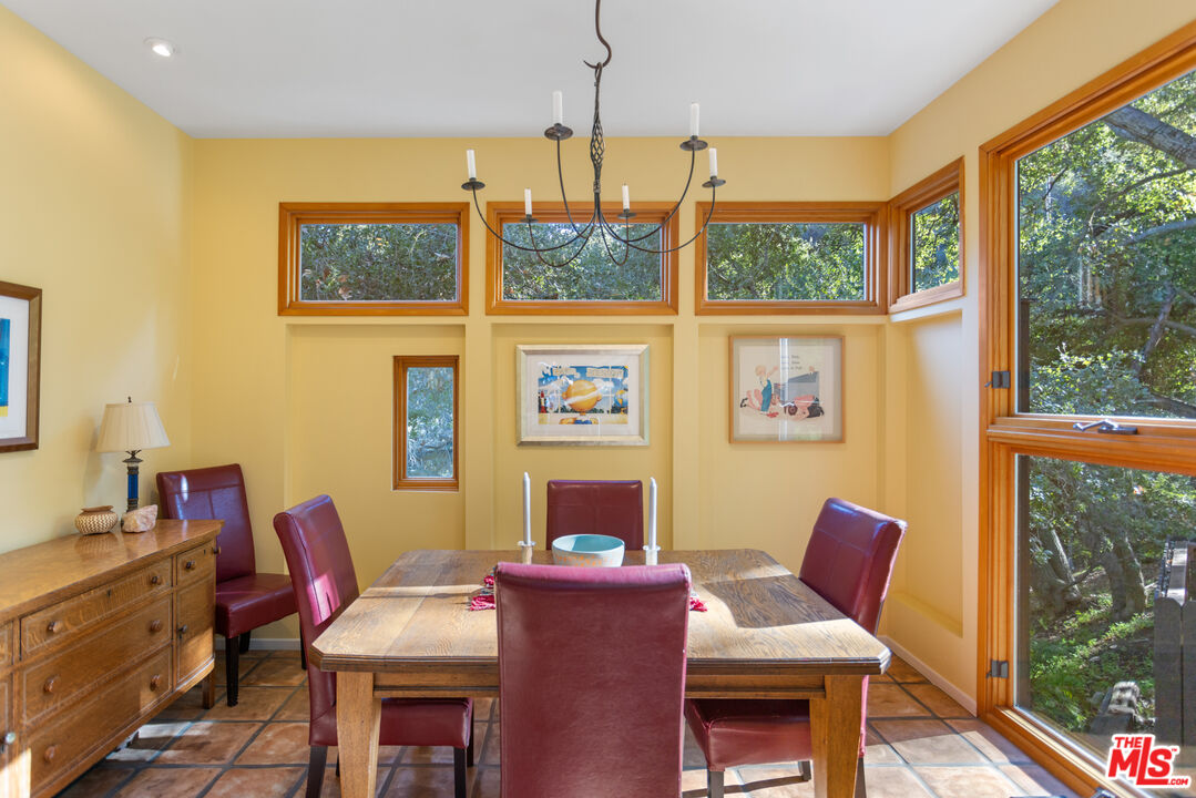3217 Canon Place Topanga, CA 90290 - Photo 12 of 49 a living room with furniture a window and a flat screen tv