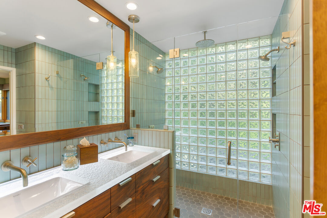 3217 Canon Place Topanga, CA 90290 - Photo 15 of 49 a bathroom with a granite countertop sink a shower and a mirror