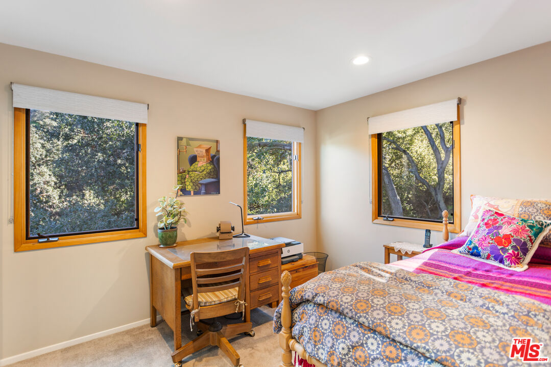 3217 Canon Place Topanga, CA 90290 - Photo 16 of 49 a bedroom with a bed and wooden floor