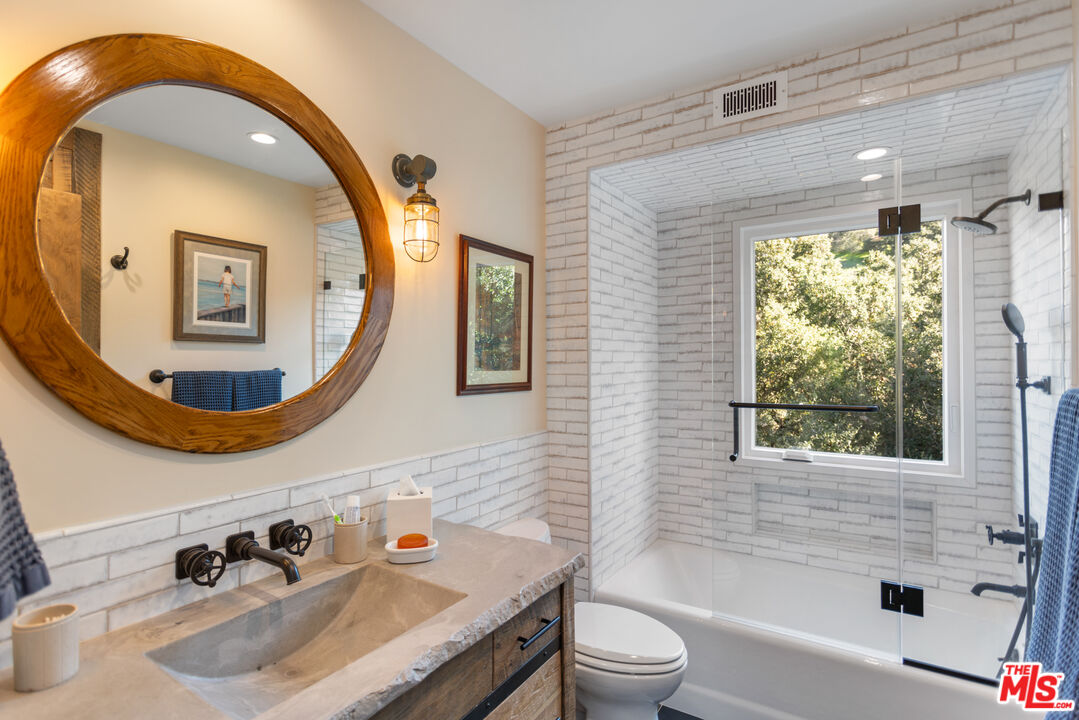 3217 Canon Place Topanga, CA 90290 - Photo 17 of 49 a bathroom with a sink and a mirror