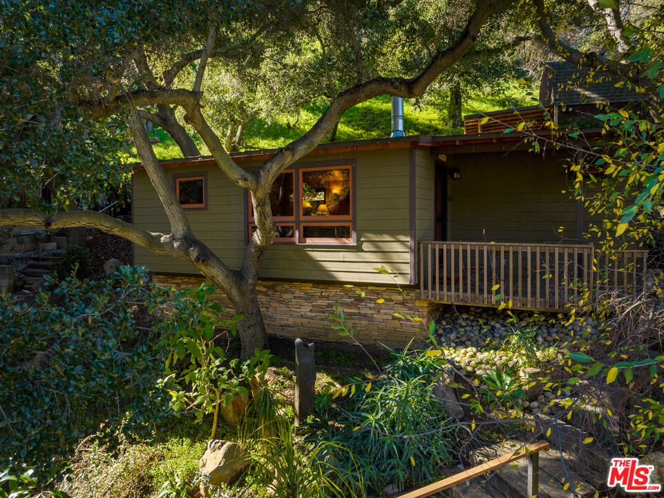 3217 Canon Place Topanga, CA 90290 - Photo 27 of 49 a view of a house with a small yard and a large tree