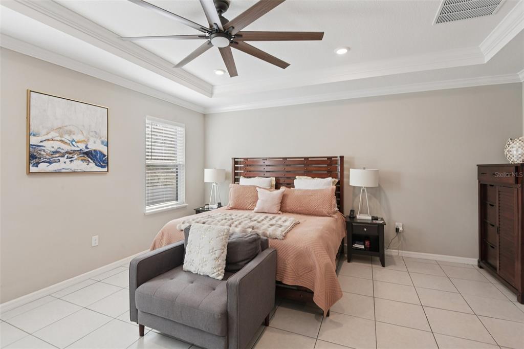 21 Mayten Court North Homosassa, FL 34446 - Photo 12 of 37 a bedroom with a bed and a chandelier