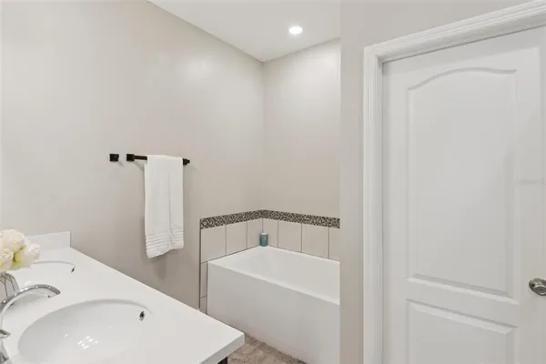 a bathroom with a bathtub and sink