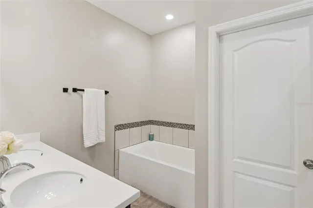 a bathroom with a bathtub and sink