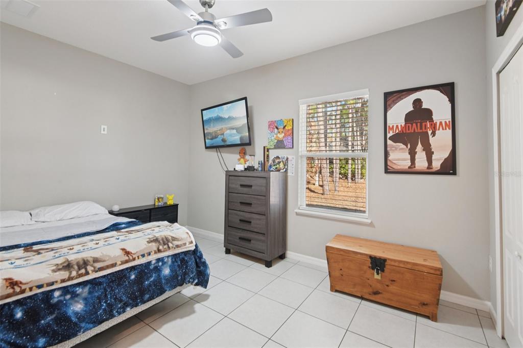 21 Mayten Court North Homosassa, FL 34446 - Photo 19 of 37 a bedroom with a bed and a chandelier