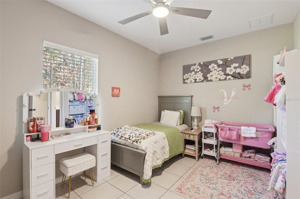 21 Mayten Court North Homosassa, FL 34446 - Photo 20 of 37 a bedroom with a bed and a chandelier