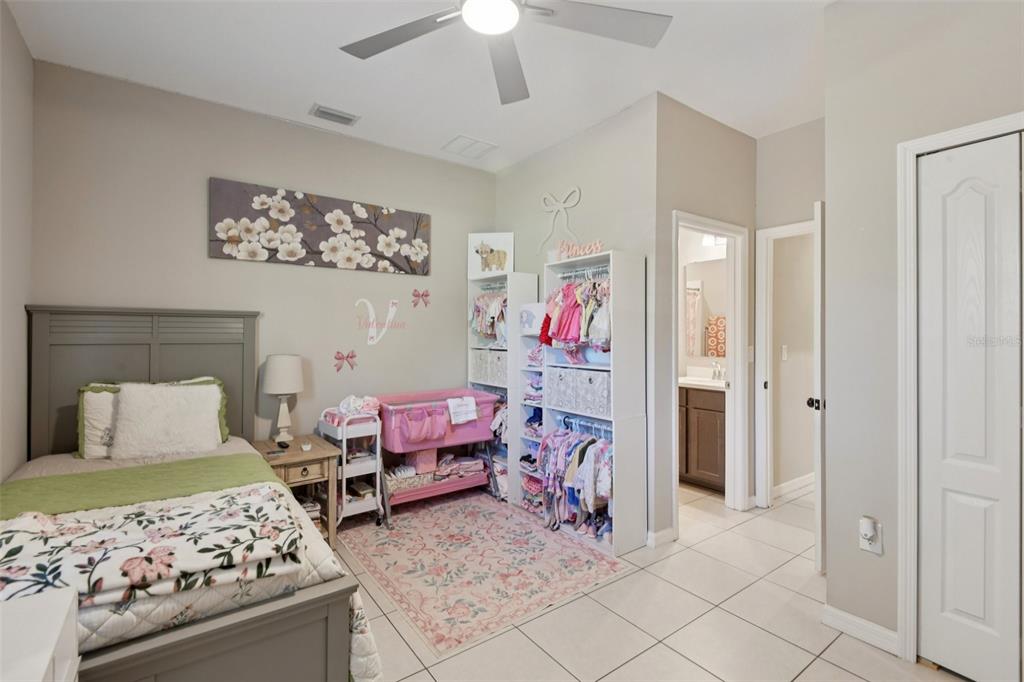 21 Mayten Court North Homosassa, FL 34446 - Photo 21 of 37 a bedroom with a bed and a chandelier