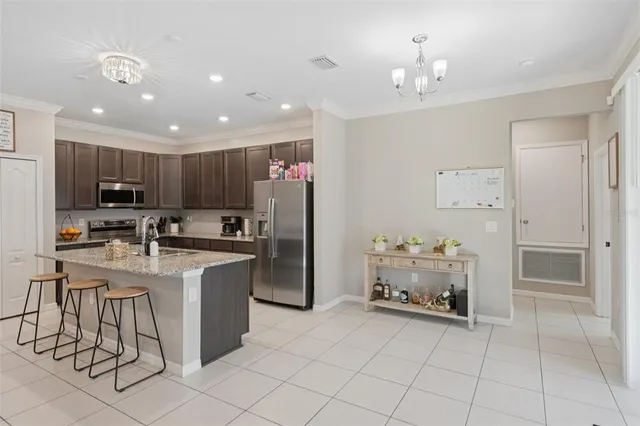 a kitchen with refrigerator and cabinets