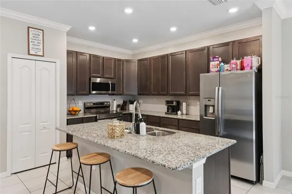 a kitchen with granite countertop stainless steel appliances and wooden cabinets