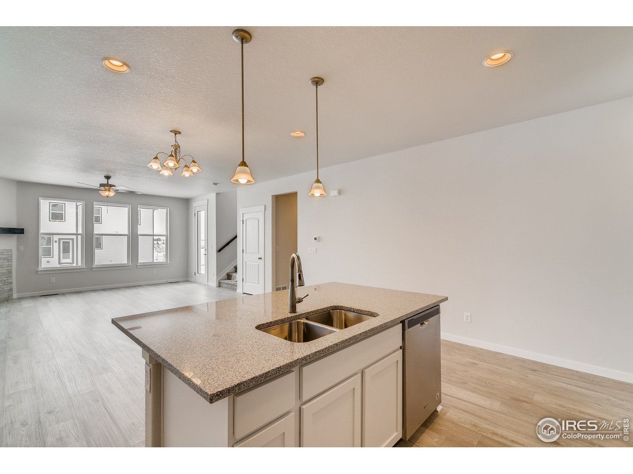 2147 Gather Drive Windsor, CO 80550 - Photo 12 of 28 a kitchen with a sink cabinets and wooden floor