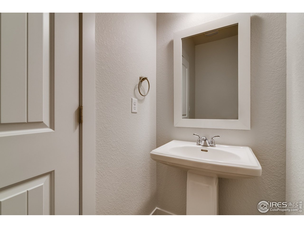 2147 Gather Drive Windsor, CO 80550 - Photo 15 of 28 a bathroom with a sink and a mirror