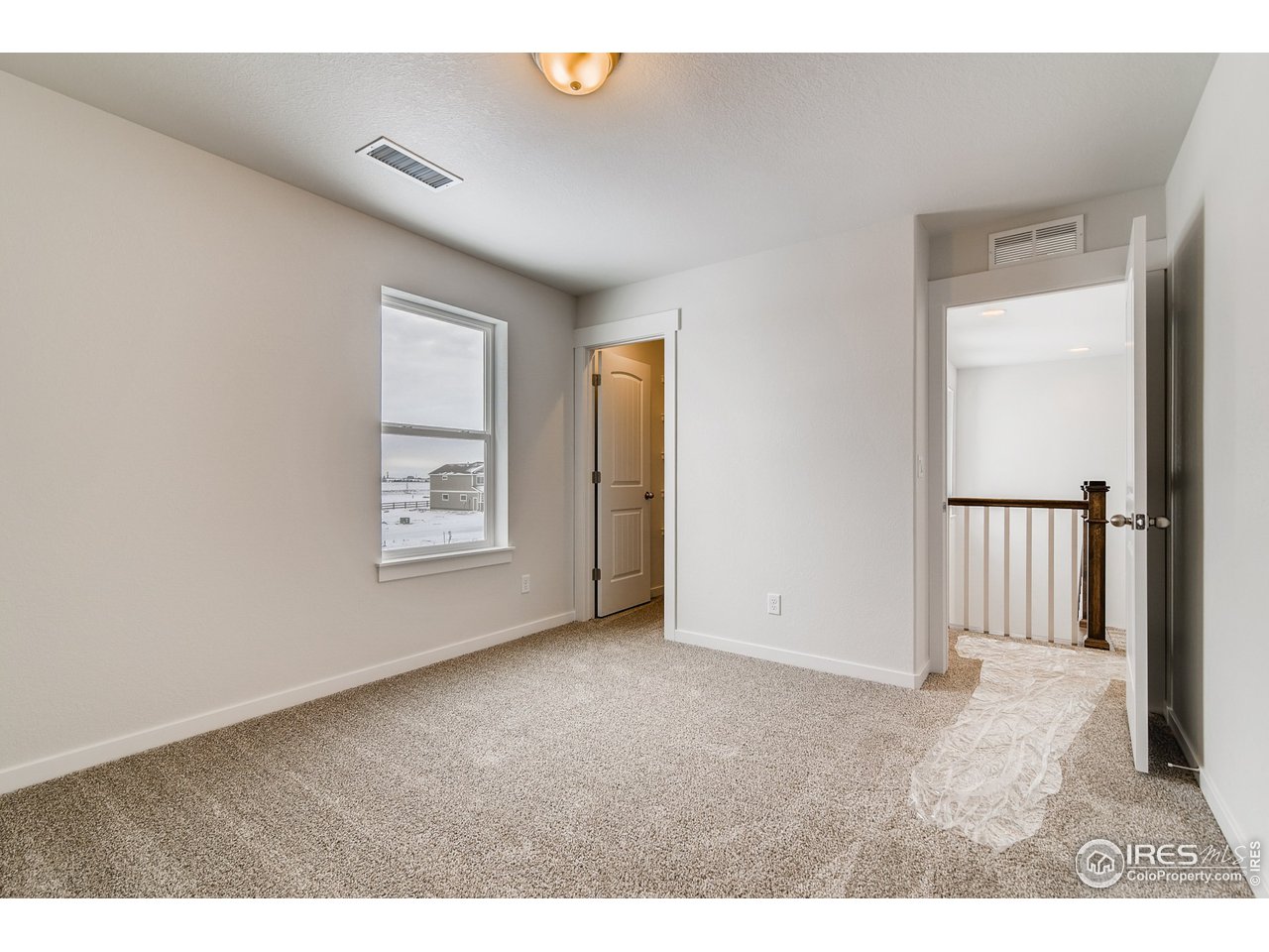 2147 Gather Drive Windsor, CO 80550 - Photo 20 of 28 a view of an empty room with a window