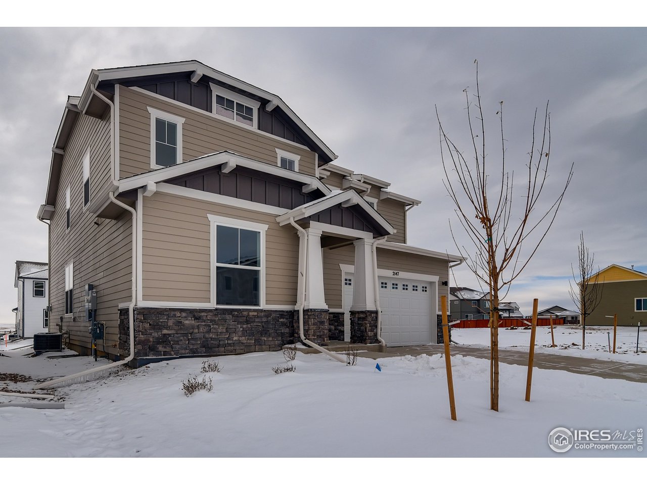 2147 Gather Drive Windsor, CO 80550 - Photo 2 of 28 a front view of a house with a yard