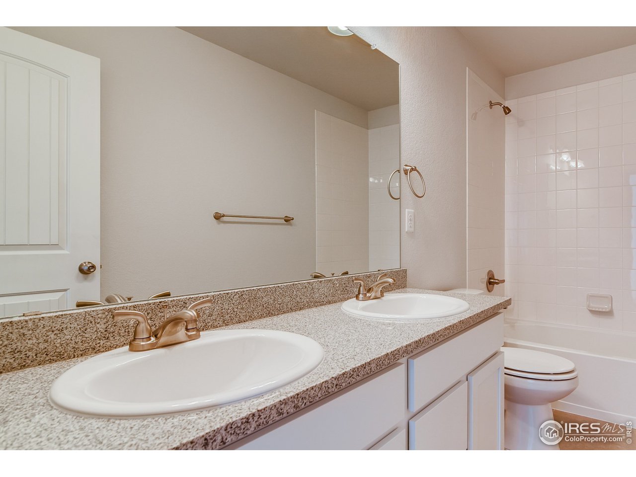 2147 Gather Drive Windsor, CO 80550 - Photo 21 of 28 a bathroom with a sink and a mirror