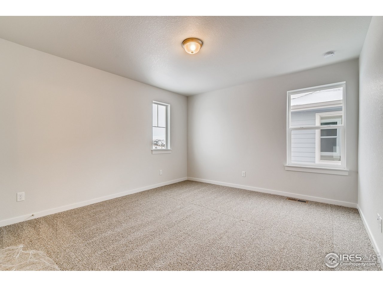 2147 Gather Drive Windsor, CO 80550 - Photo 23 of 28 a view of an empty room with a window