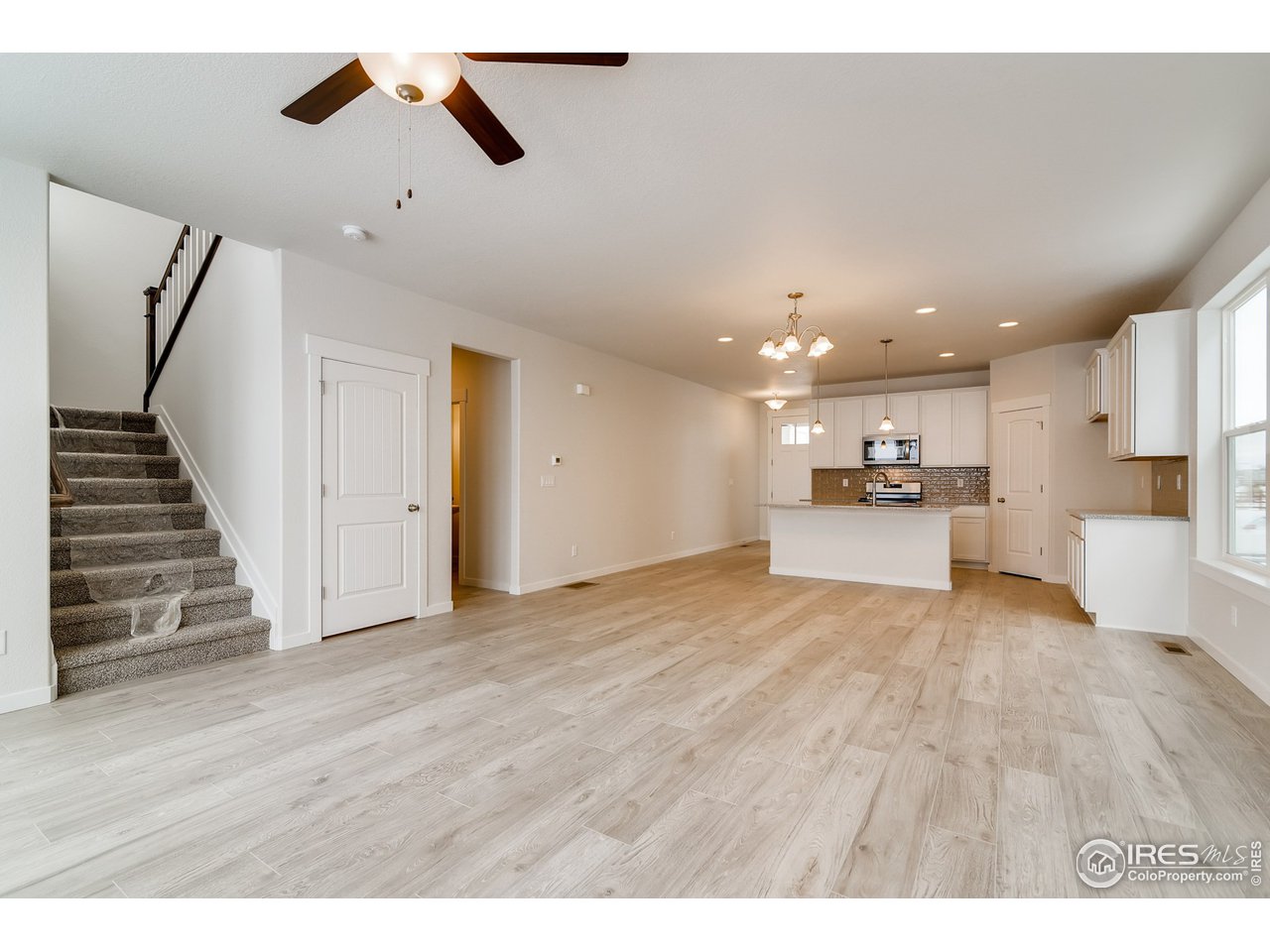 2147 Gather Drive Windsor, CO 80550 - Photo 8 of 28 a view of kitchen and hall with wooden floor