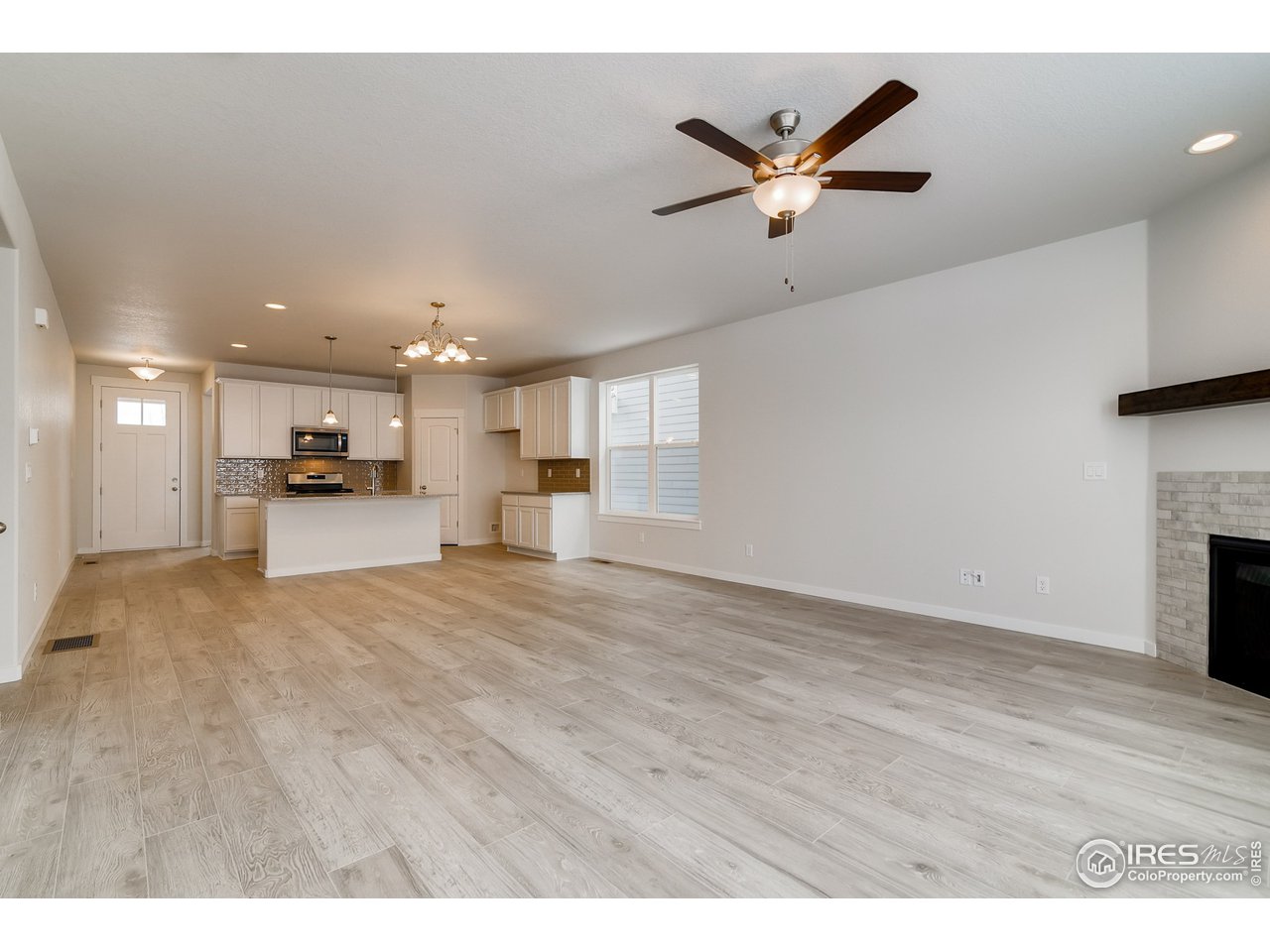 2147 Gather Drive Windsor, CO 80550 - Photo 9 of 28 a view of a kitchen with a sink and a stove