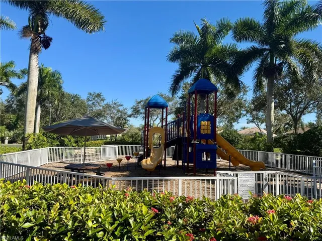 a view of a house with a yard and potted plants