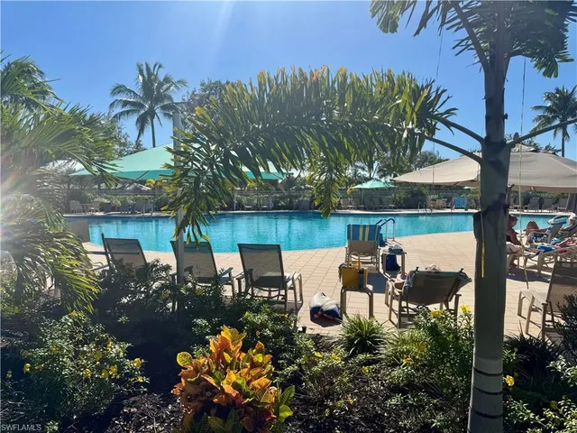 a view of a patio with table and chairs potted plants and large tree