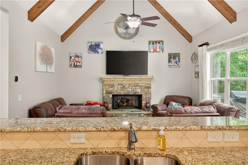 5250 Kendalls Way Cumming, GA 30041 - Photo 14 of 42 a living room with fireplace furniture and a flat screen tv