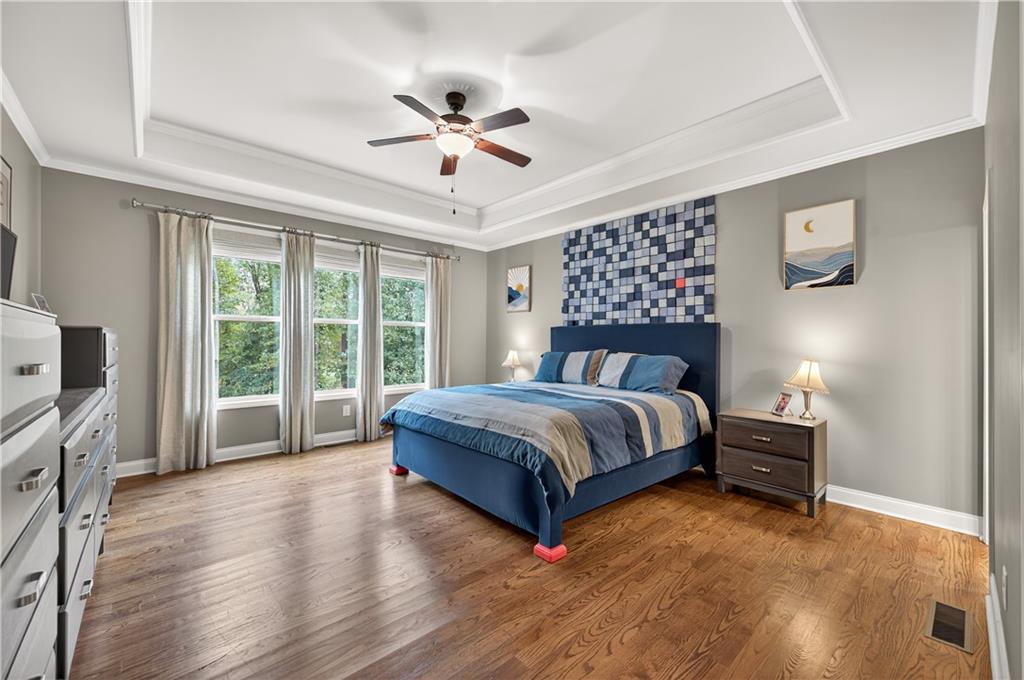 5250 Kendalls Way Cumming, GA 30041 - Photo 16 of 42 a bedroom with a large bed and a tv