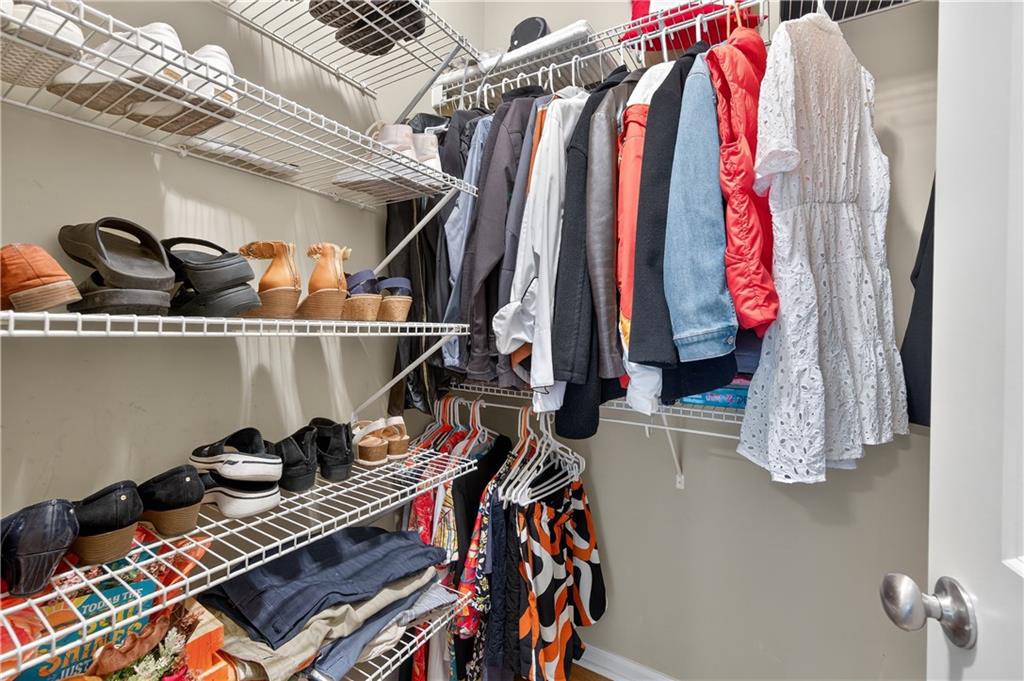 5250 Kendalls Way Cumming, GA 30041 - Photo 21 of 42 a view of walk in closet with clothes and shoes