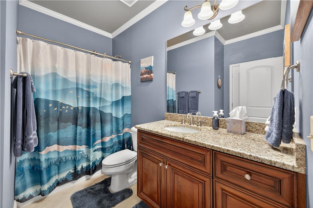 5250 Kendalls Way Cumming, GA 30041 - Photo 23 of 42 a bathroom with a granite countertop sink toilet and shower
