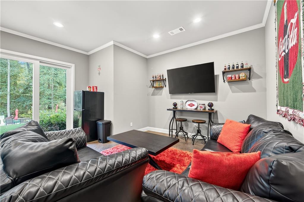 5250 Kendalls Way Cumming, GA 30041 - Photo 33 of 42 a living room with furniture and a flat screen tv