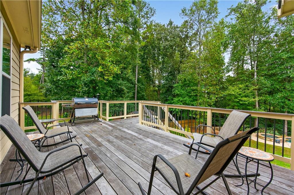 5250 Kendalls Way Cumming, GA 30041 - Photo 36 of 42 a view of a roof deck with chair and wooden floor