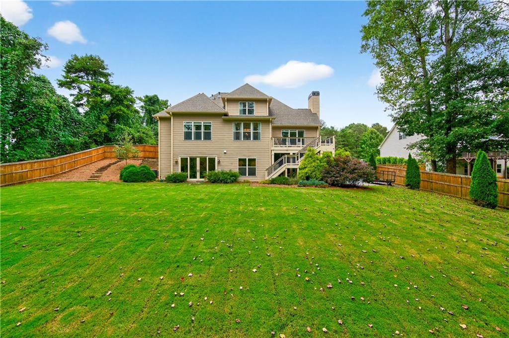 5250 Kendalls Way Cumming, GA 30041 - Photo 39 of 42 a view of a house with a big yard and large trees