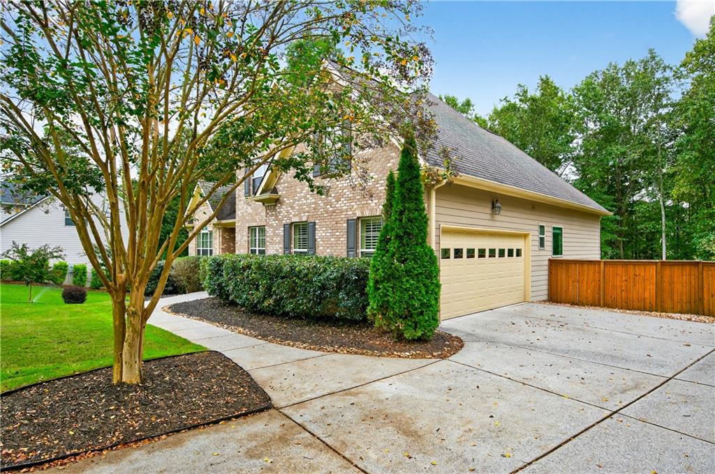 5250 Kendalls Way Cumming, GA 30041 - Photo 5 of 42 a front view of a house with a yard and garage