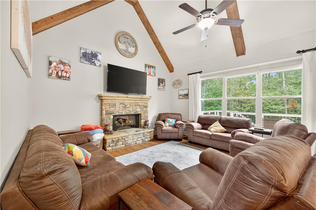 5250 Kendalls Way Cumming, GA 30041 - Photo 9 of 42 a living room with furniture a fireplace and a flat screen tv