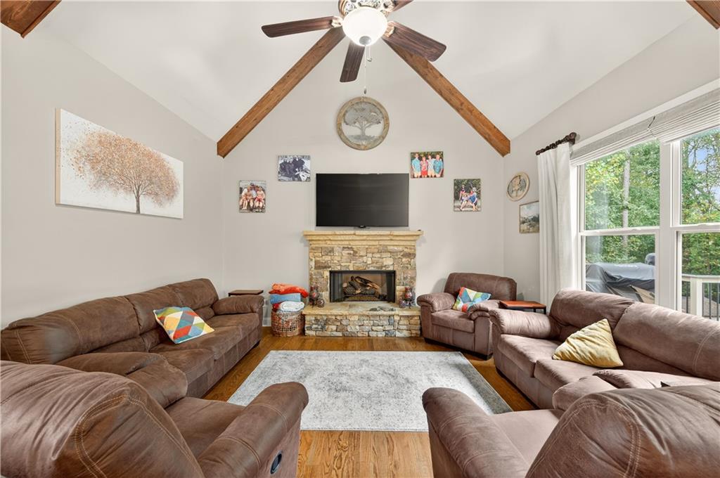 5250 Kendalls Way Cumming, GA 30041 - Photo 10 of 42 a living room with furniture a fireplace and a large window