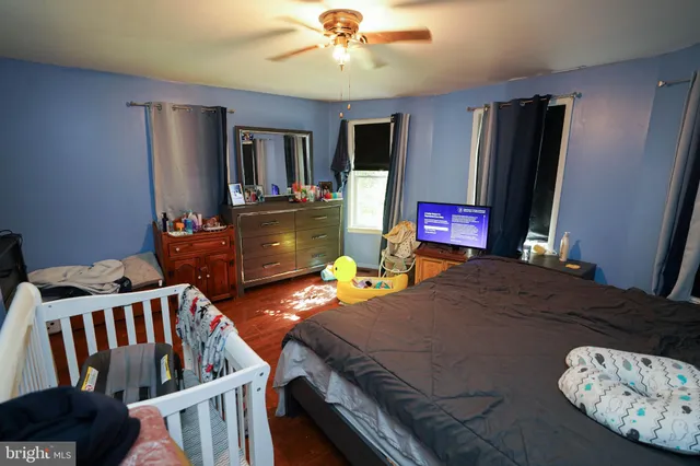 a bedroom with two beds and a flat screen tv
