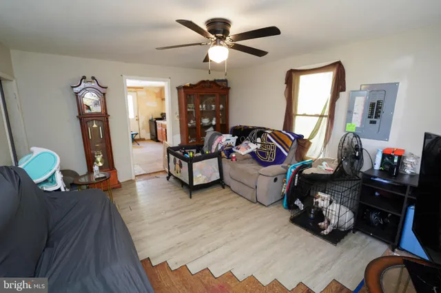 a living room with furniture a window and a flat screen tv