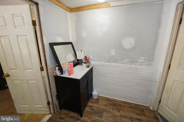 a bathroom with a sink a mirror and shower