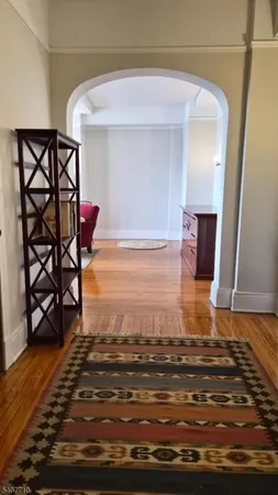 a view of a livingroom with wooden floor and chair