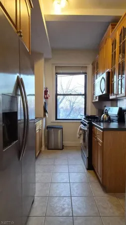 a kitchen with stainless steel appliances a refrigerator and a stove