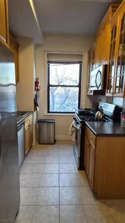a kitchen with stainless steel appliances a stove a sink and a cabinets