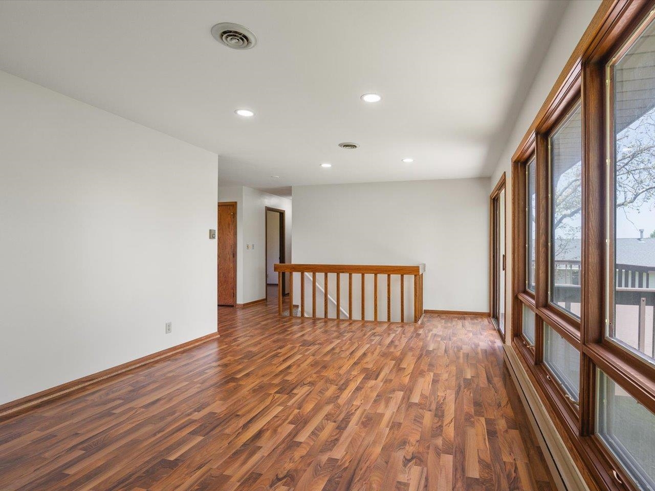 136 Lake Summerset Road Lake Summerset, IL 61019 - Photo 11 of 47 a view of a room with wooden floor and iron stairs