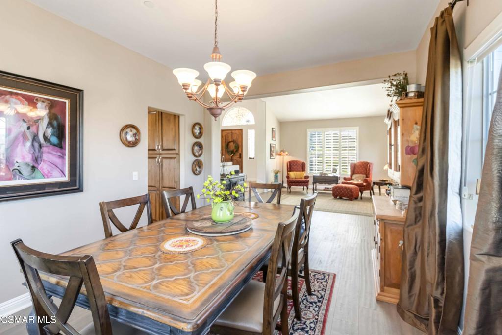 1308 Gonzales Road Simi Valley, CA 93063 - Photo 11 of 48 a view of a dining room with furniture a chandelier and wooden floor