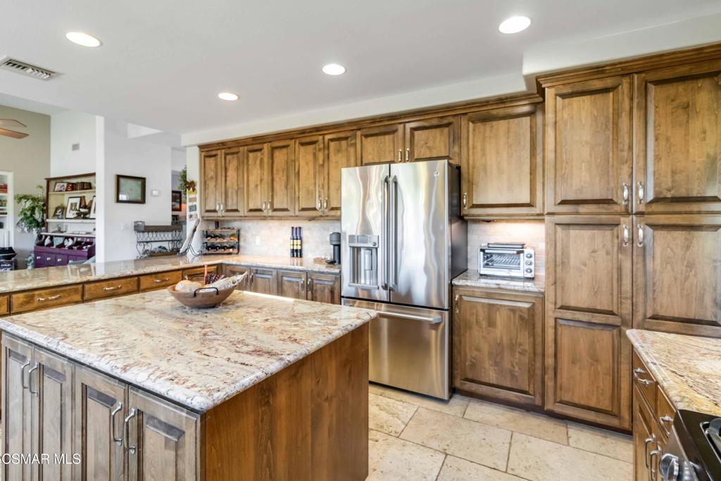 1308 Gonzales Road Simi Valley, CA 93063 - Photo 13 of 48 a kitchen with kitchen island granite countertop a sink a counter top stainless steel appliances cabinets and a counter top space