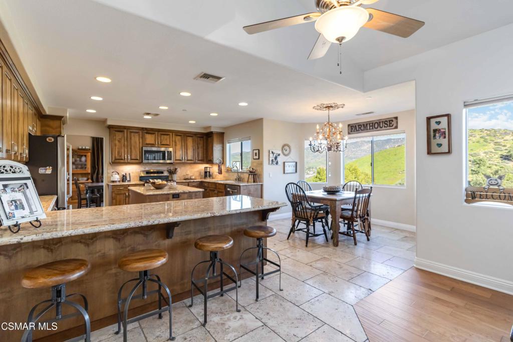 1308 Gonzales Road Simi Valley, CA 93063 - Photo 16 of 48 a large kitchen with a table and chairs