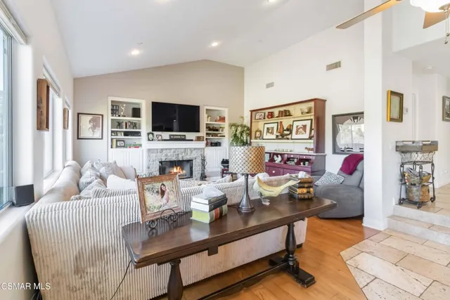 a living room with fireplace furniture and a flat screen tv