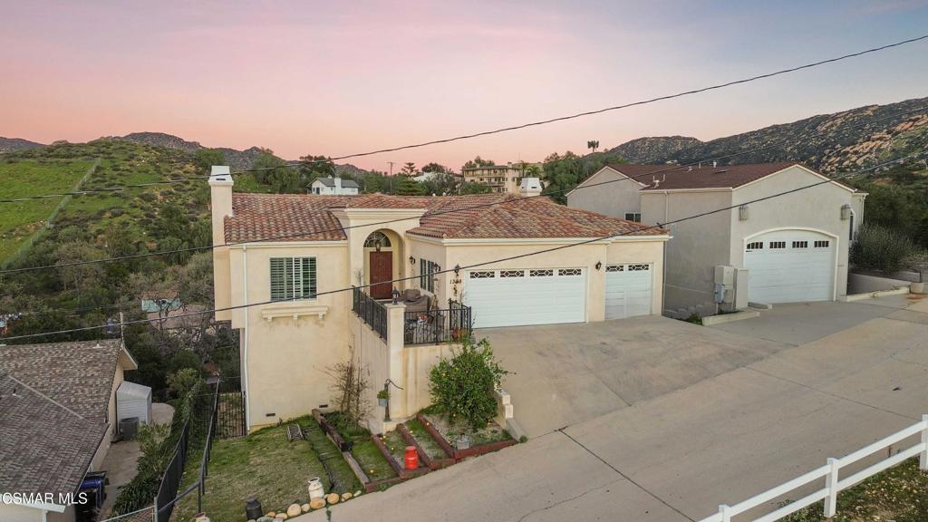 1308 Gonzales Road Simi Valley, CA 93063 - Photo 2 of 48 an aerial view of a house with a yard