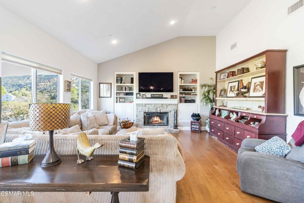 1308 Gonzales Road Simi Valley, CA 93063 - Photo 21 of 48 a living room with furniture a fireplace and a flat screen tv