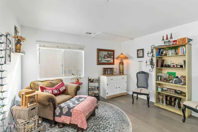 a bedroom with furniture and a window