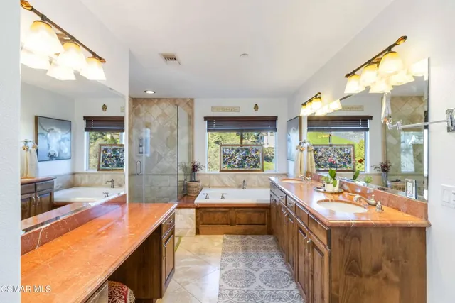 a large kitchen with kitchen island a large window