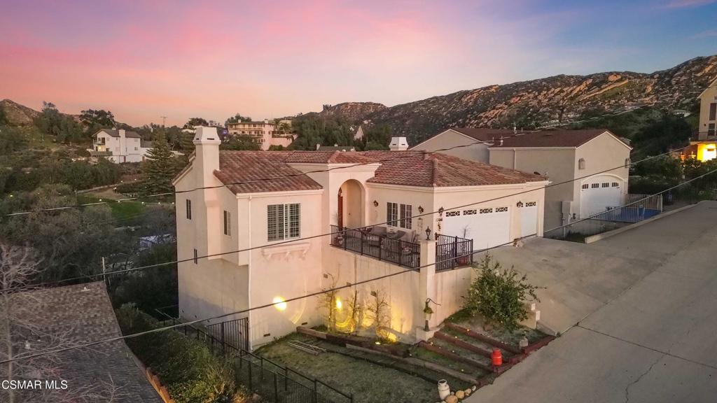 1308 Gonzales Road Simi Valley, CA 93063 - Photo 3 of 48 a view of a white house with a yard