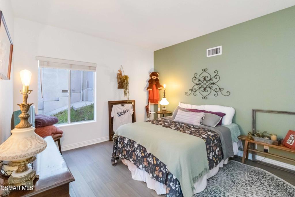 1308 Gonzales Road Simi Valley, CA 93063 - Photo 34 of 48 a bedroom with a bed and wooden floor